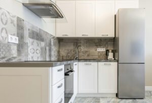 an image of kitchen with a fridge that has tight gap